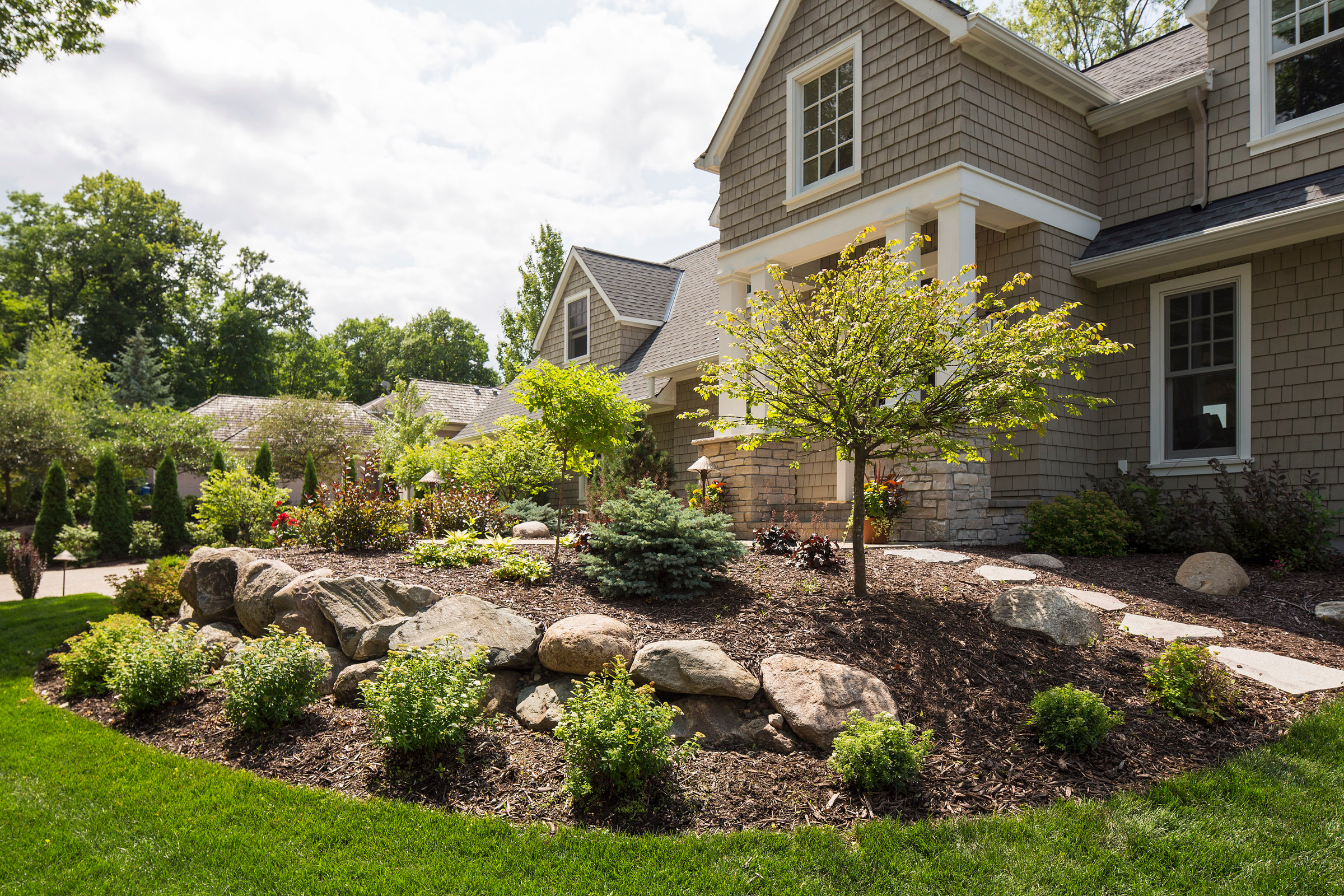 Front Yard With Boulder Wall And Shrub, Landscape Boulders Minneapolis