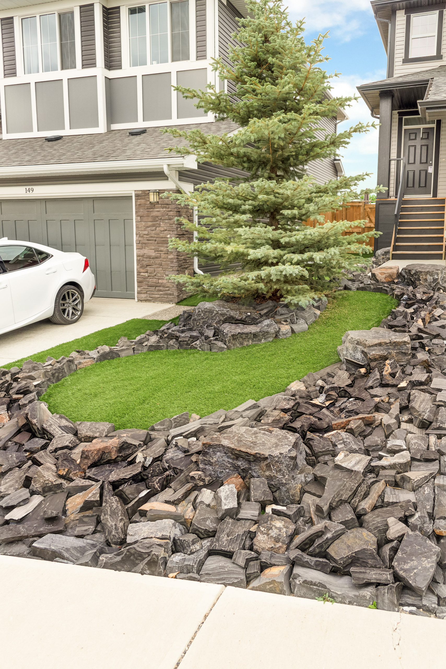 Front Yard With Rundle Stone Tailings Synthetic Grass Rustic Landscape Calgary By Solkor Creating Stunning Outdoor Living Spaces Houzz