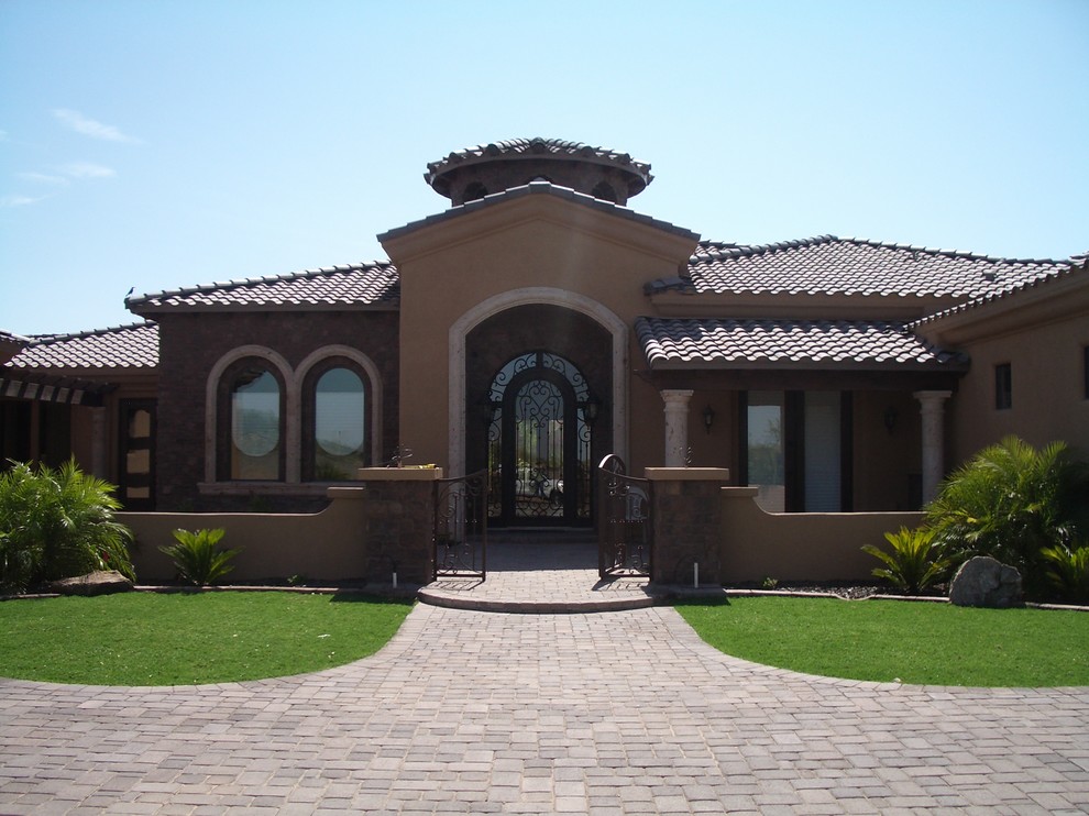 Photo of a large world-inspired front formal full sun garden for summer in Phoenix with a garden path and concrete paving.