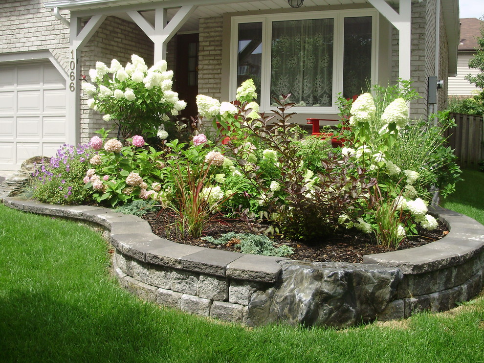 This is an example of a small traditional full sun front yard garden path in Toronto.