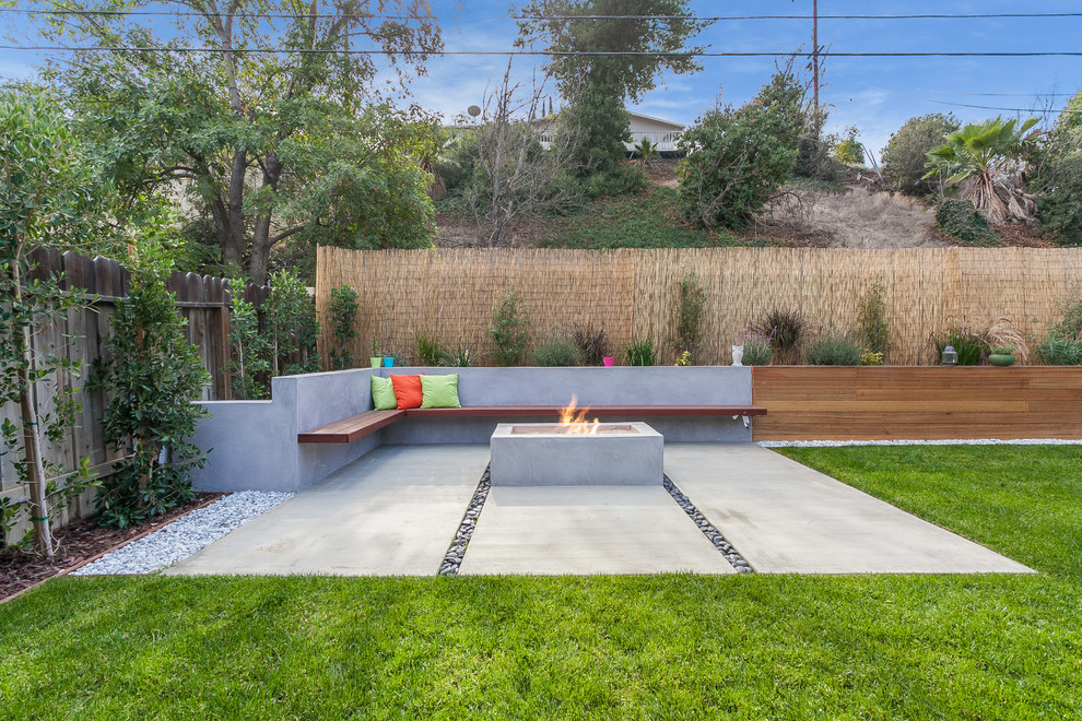 Стильный дизайн: большой солнечный, летний регулярный сад на заднем дворе в стиле модернизм с местом для костра, мощением тротуарной плиткой и хорошей освещенностью - последний тренд