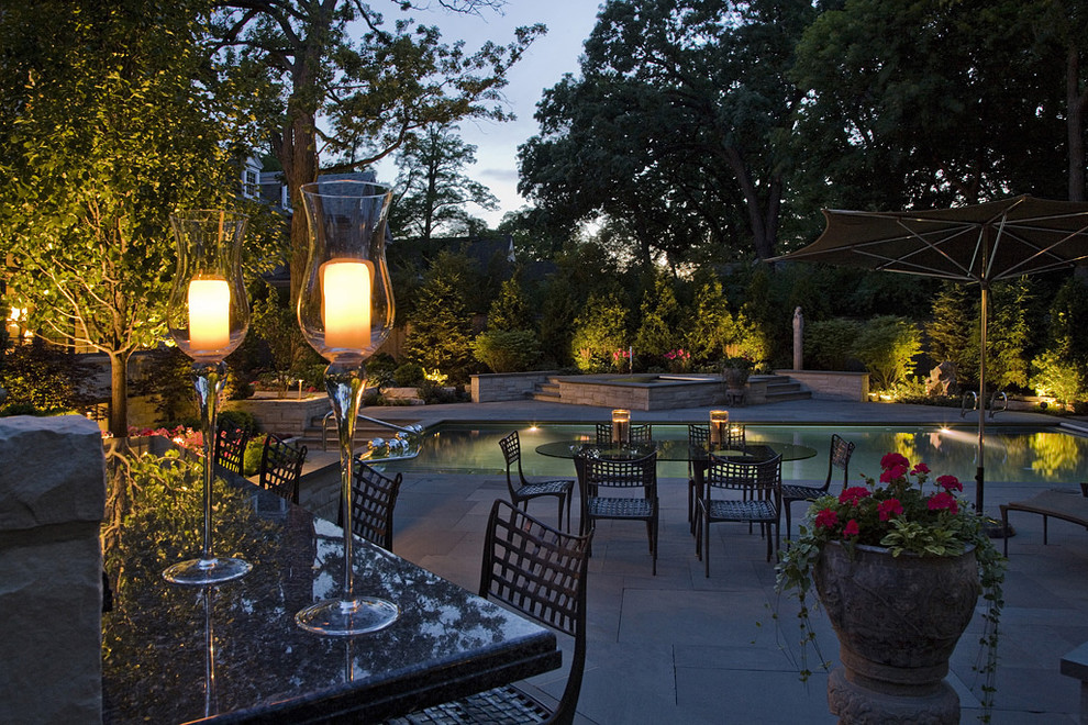 Design ideas for a large traditional partial sun backyard stone water fountain landscape in Chicago for summer.
