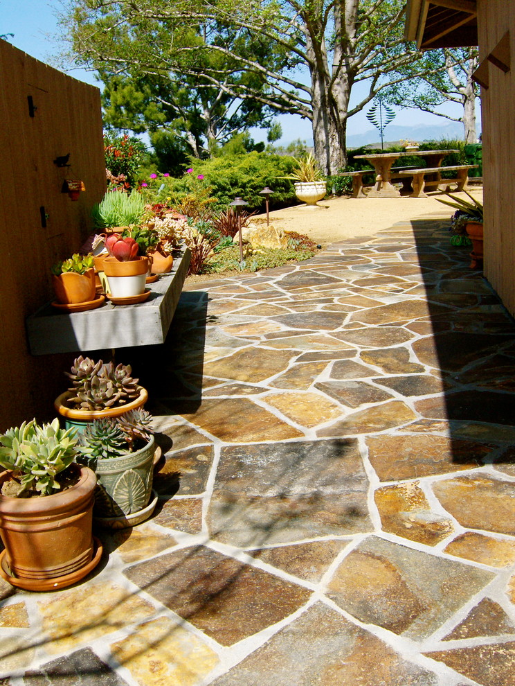 Design ideas for a medium sized mediterranean side xeriscape fully shaded garden for summer in Los Angeles with natural stone paving and a garden path.