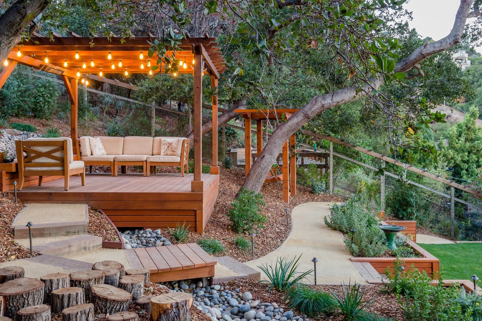 Photo of a large rustic drought-tolerant and partial sun backyard landscaping in San Francisco with decking and a pergola.