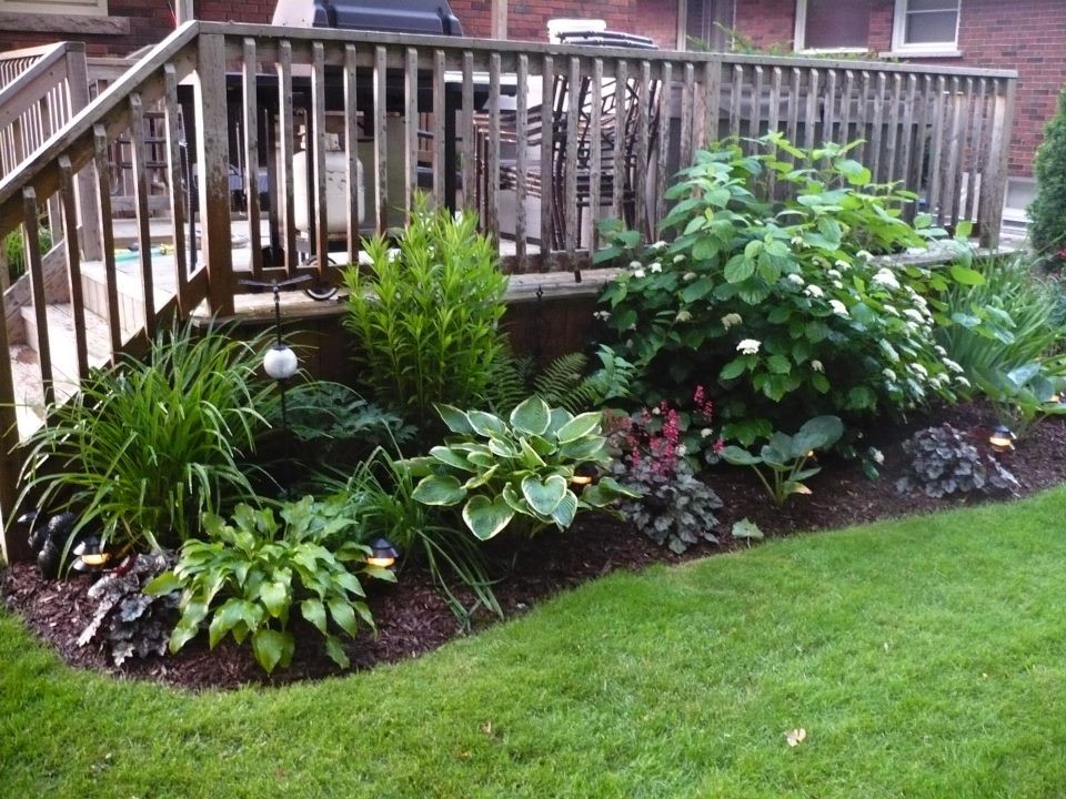 Design ideas for a large traditional front fully shaded garden in Toronto with a garden path and decking.