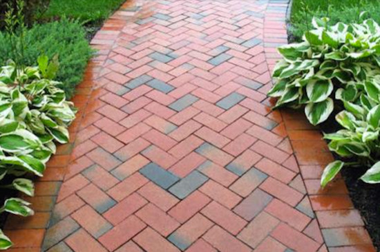 Photo of a mid-sized traditional front yard brick garden path in Other.
