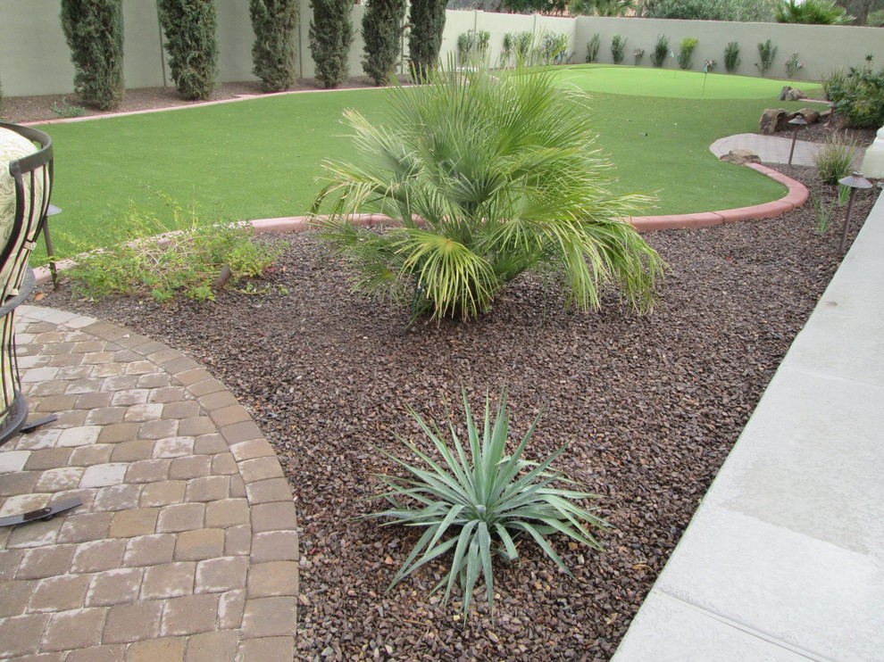 Inspiration for a large back full sun garden in Phoenix with a garden path and natural stone paving.