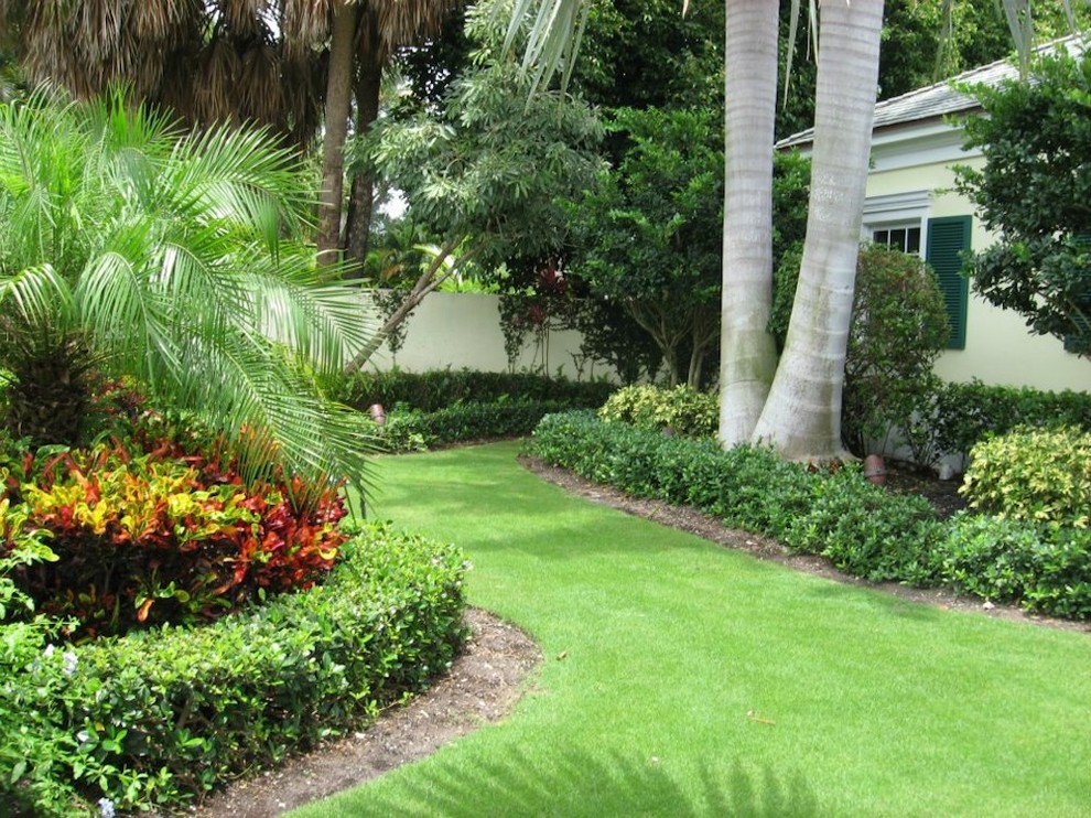 Design ideas for a mid-sized tropical partial sun front yard brick garden path in Miami for summer.