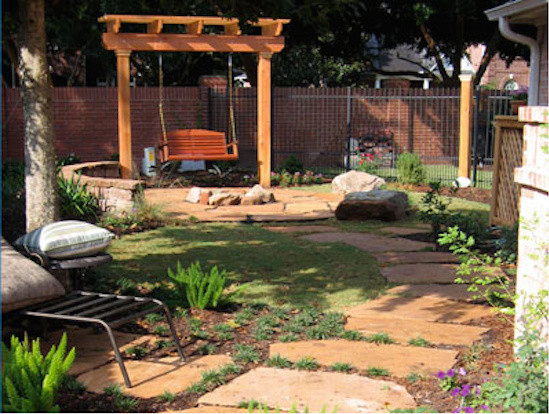 This is an example of a mid-sized transitional partial sun backyard stone formal garden in Houston with a fire pit for summer.
