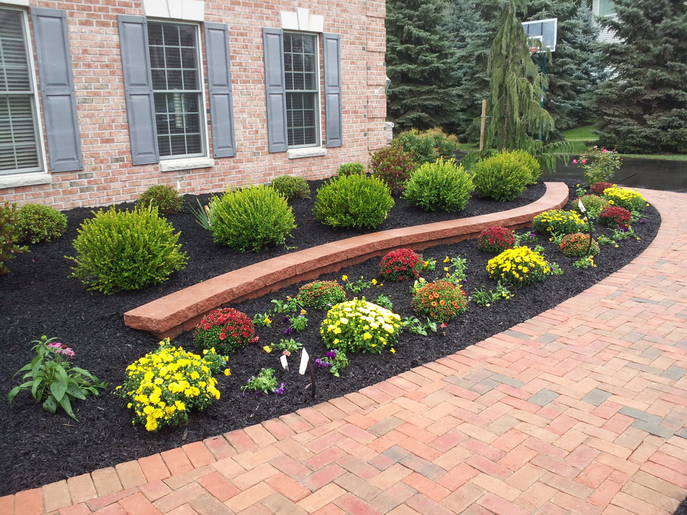 This is an example of a traditional full sun front yard mulch formal garden in New York.