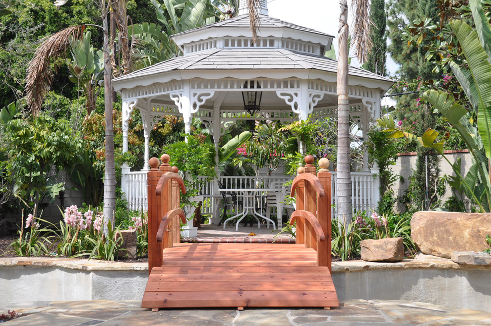 Ispirazione per un giardino tropicale con fontane e gazebo