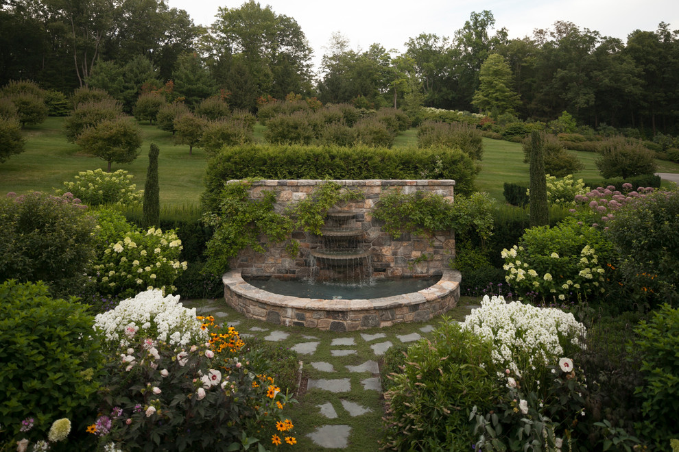 Idee per un grande giardino formale chic esposto in pieno sole dietro casa in estate con pavimentazioni in pietra naturale