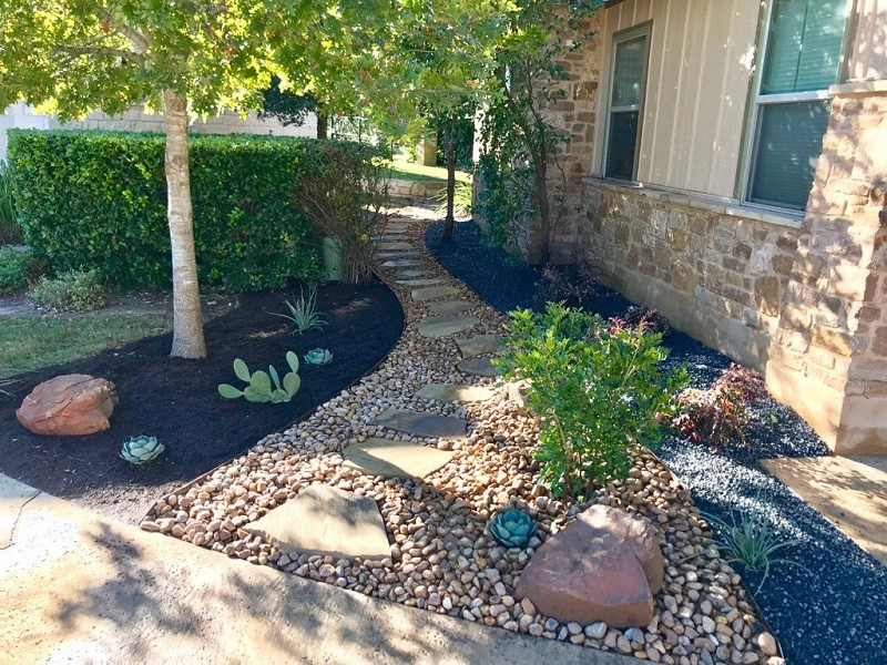 Mittelgroßer, Halbschattiger Moderner Garten hinter dem Haus mit Blumenbeet und Flusssteinen in Austin