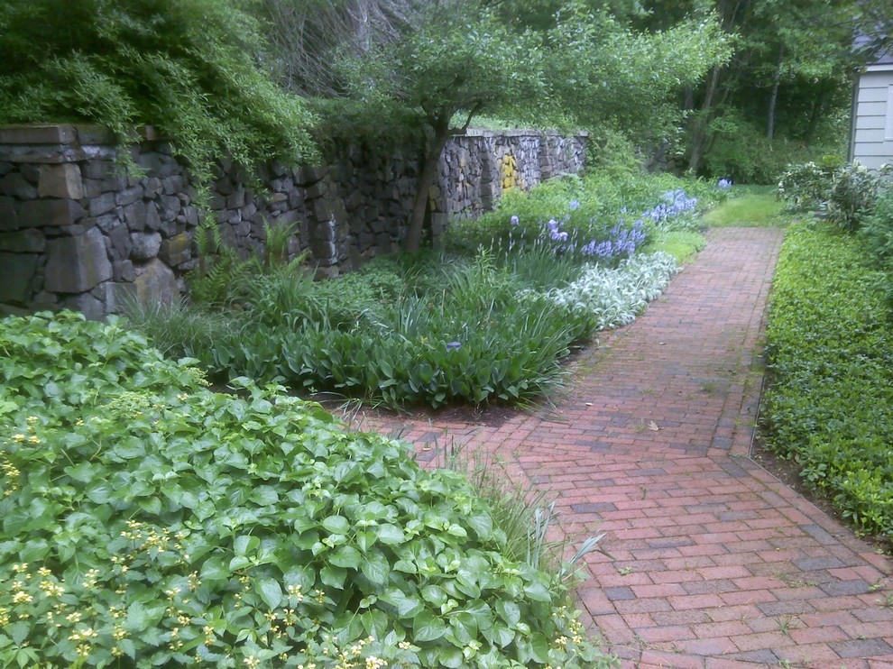 Esempio di un giardino vittoriano esposto a mezz'ombra di medie dimensioni e davanti casa in primavera con un ingresso o sentiero e pavimentazioni in mattoni