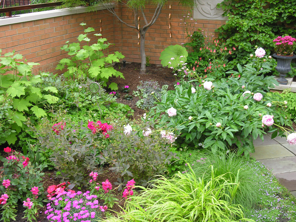 This is an example of a large contemporary full sun backyard stone formal garden in Chicago.