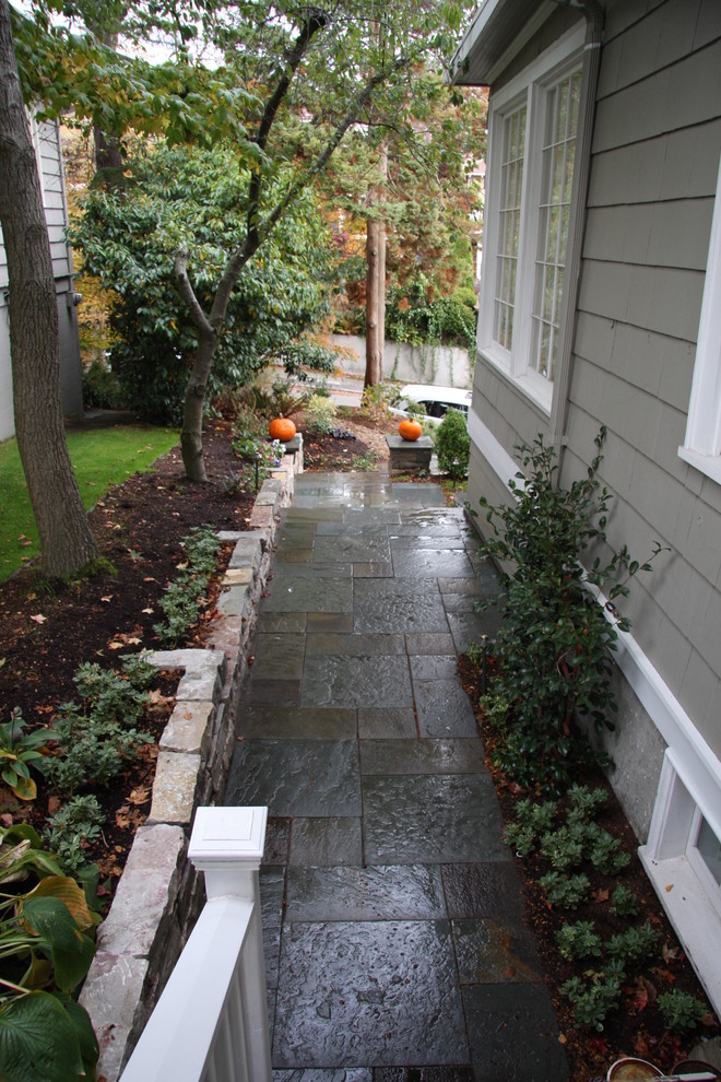 Photo of a small traditional partial sun side yard stone landscaping in Seattle.