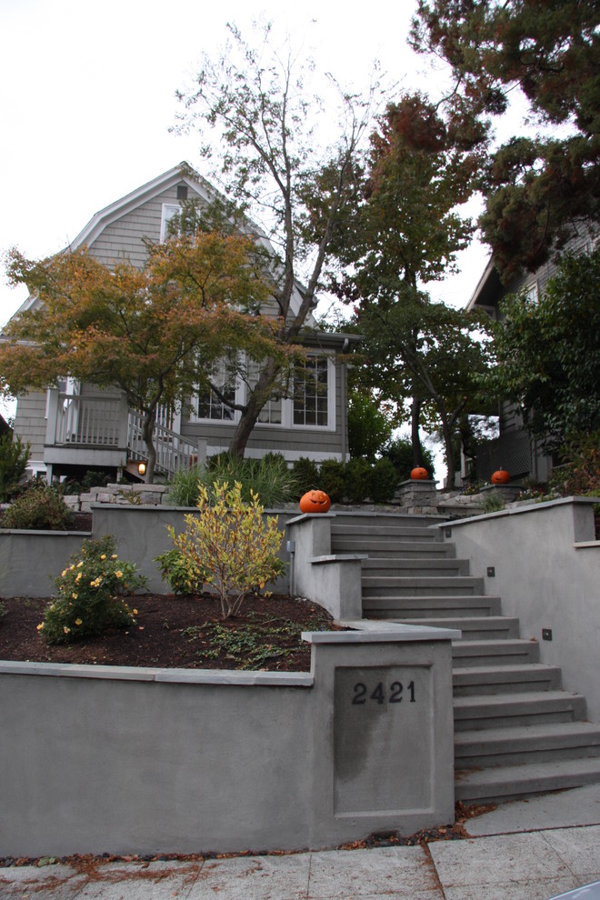 This is an example of a small traditional partial sun front yard concrete paver formal garden in Seattle.