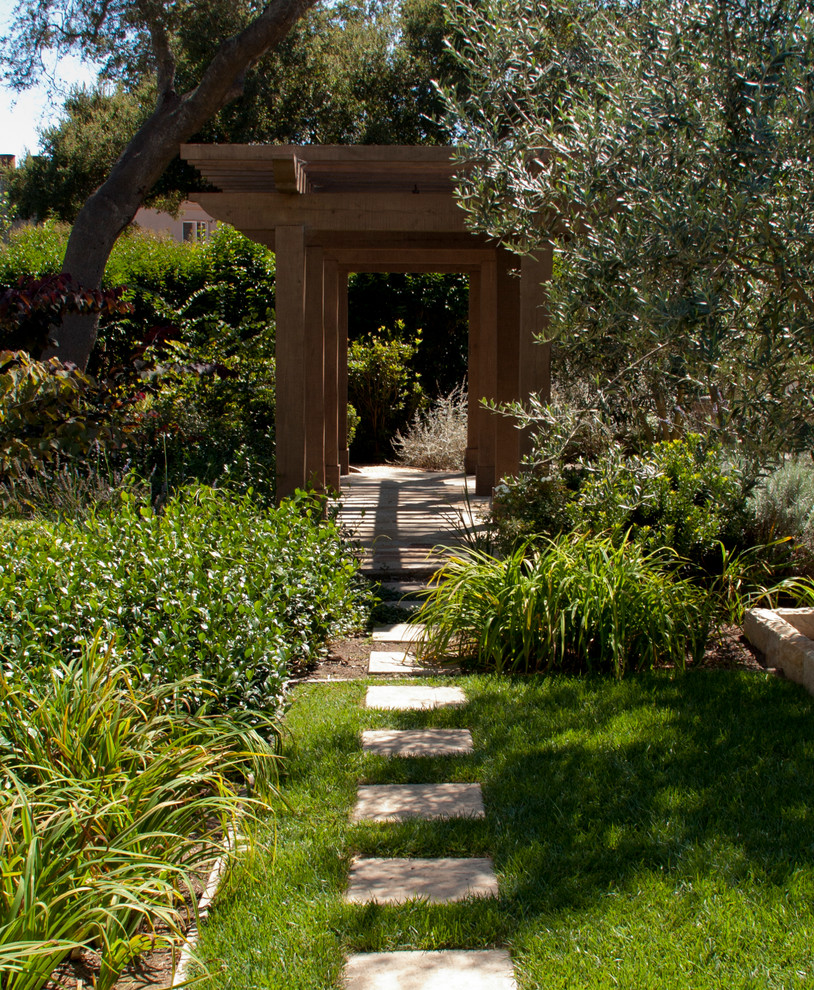 This is an example of a mid-sized mediterranean partial sun backyard concrete paver landscaping in Santa Barbara for summer.