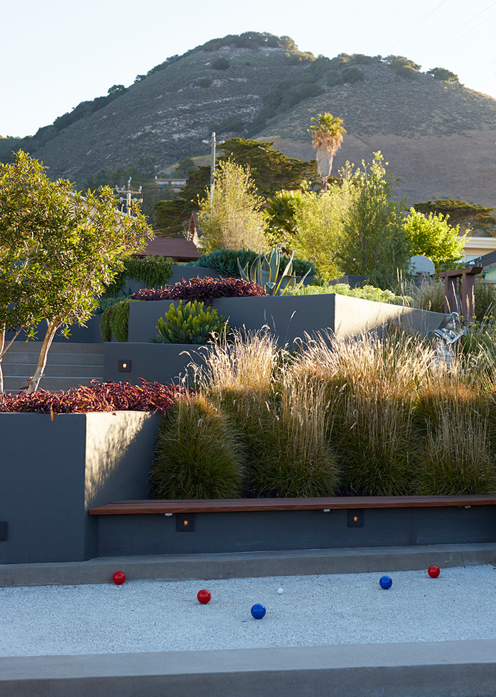 Contemporary sloped garden in San Luis Obispo with an outdoor sport court.