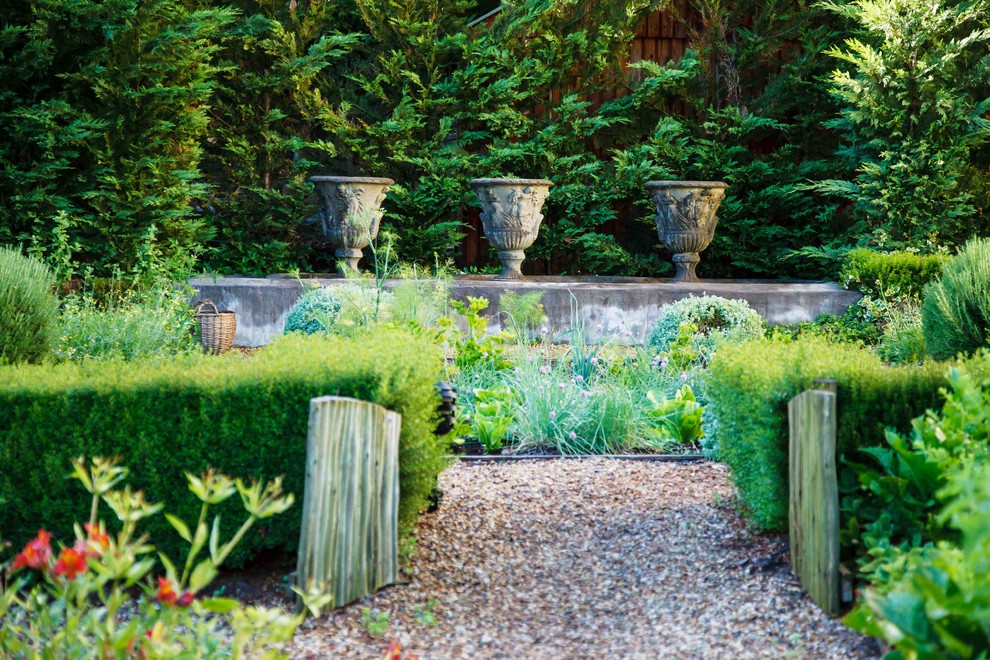 Immagine di un ampio giardino tradizionale dietro casa con un giardino in vaso e ghiaia