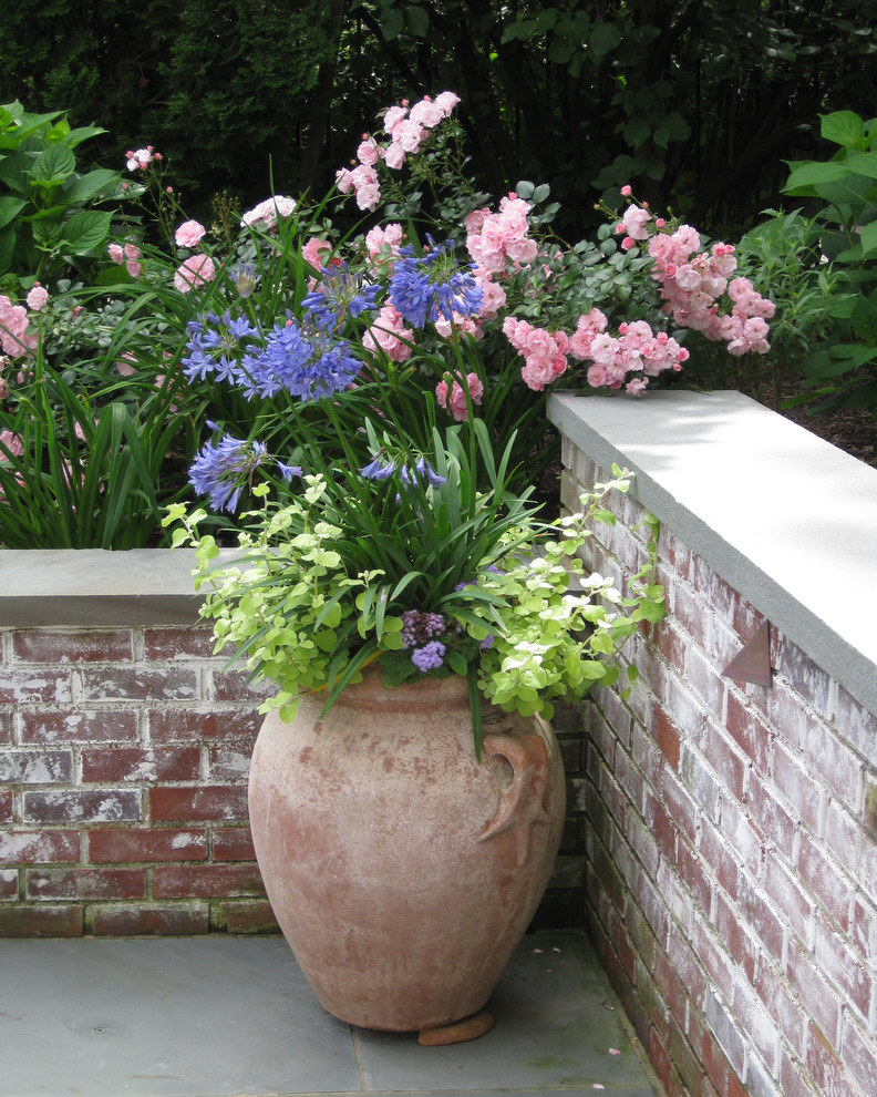 Inspiration for a small traditional shade side yard stone landscaping in New York.