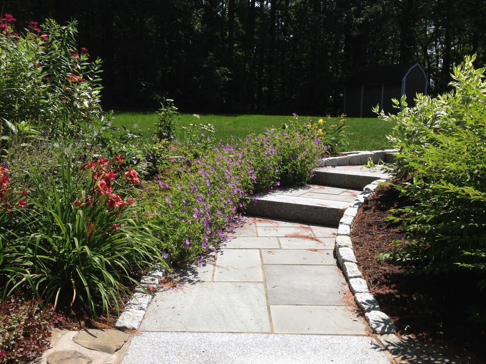 Inspiration for a mid-sized transitional full sun front yard stone landscaping in Boston for spring.