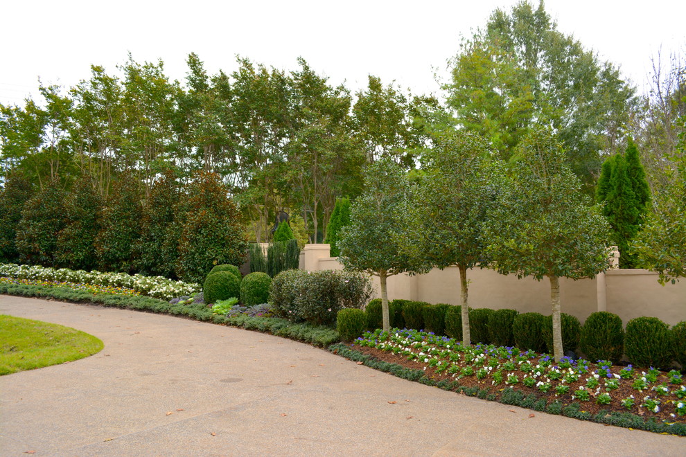 This is an example of a large traditional partial sun front yard formal garden in Other for fall.