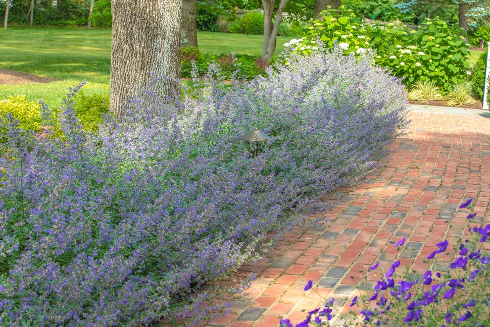 Inspiration for a mid-sized traditional partial sun backyard brick landscaping in New York for summer.