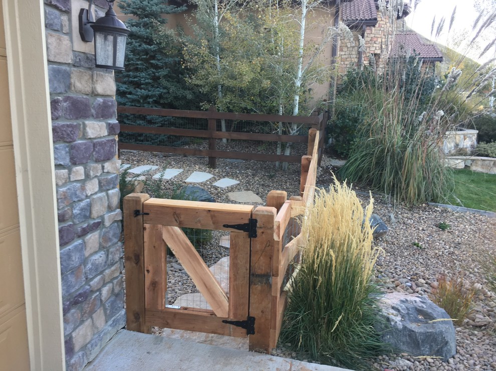 This is an example of a large rustic side xeriscape garden for summer in Denver.