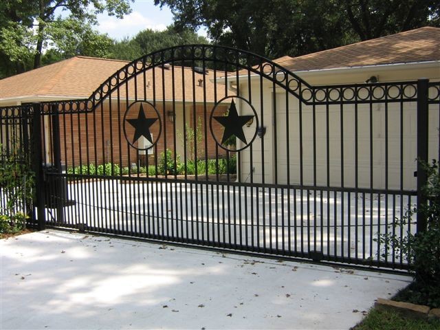 Photo of a large traditional front driveway full sun garden for spring in Houston with concrete paving.