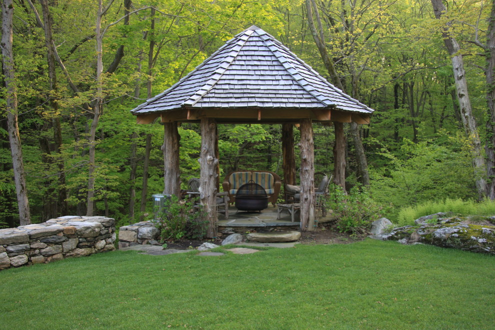 This is an example of a rustic garden in New York with a fire feature.