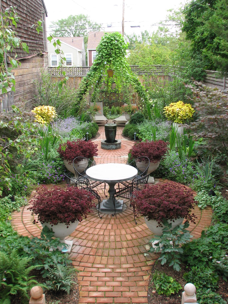 Inspiration for a mid-sized traditional backyard brick landscaping in New York.