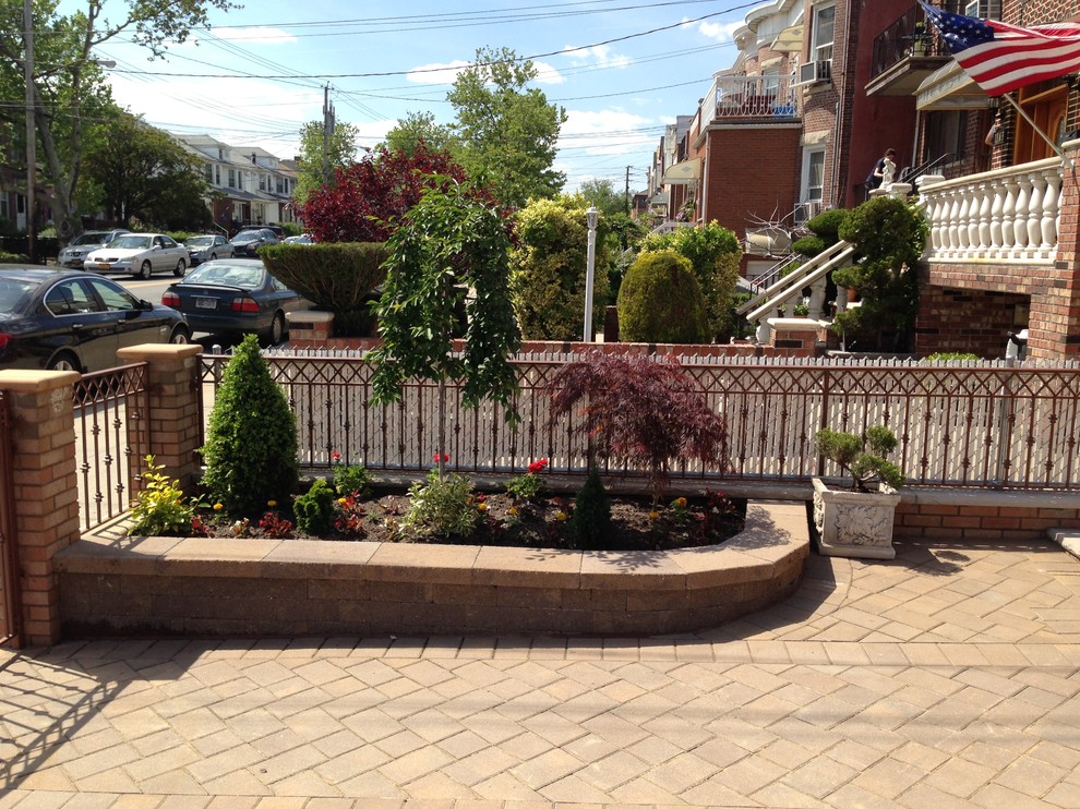Inspiration for a small traditional full sun front yard concrete paver retaining wall landscape in New York for spring.