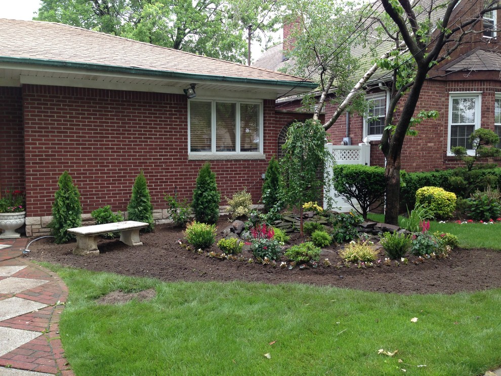 Photo of a small traditional partial sun front yard formal garden in New York for spring.