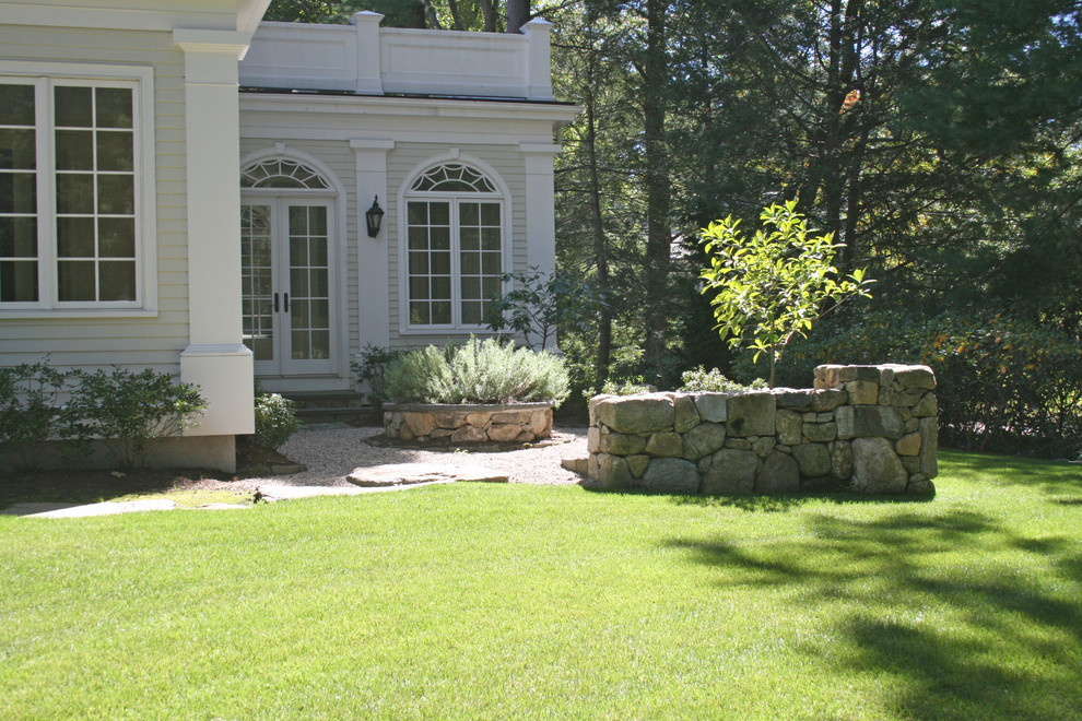 Inspiration for a large traditional side formal full sun garden for summer in Other with gravel.