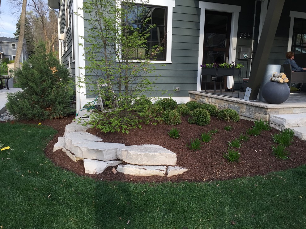 Photo of a small modern partial sun front yard mulch retaining wall landscape in Chicago for summer.