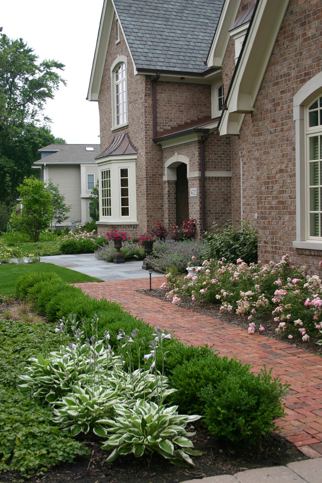 This is an example of a traditional full sun front yard brick landscaping in Chicago for summer.