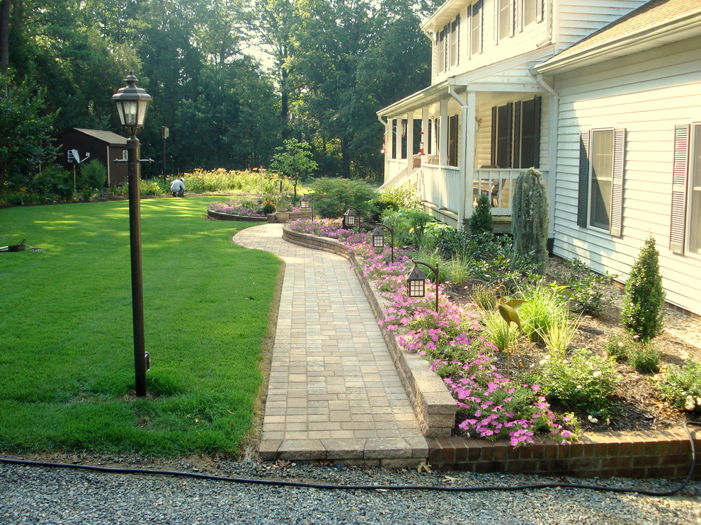 Стильный дизайн: весенний участок и сад среднего размера на переднем дворе в классическом стиле с подпорной стенкой, полуденной тенью и мощением тротуарной плиткой - последний тренд