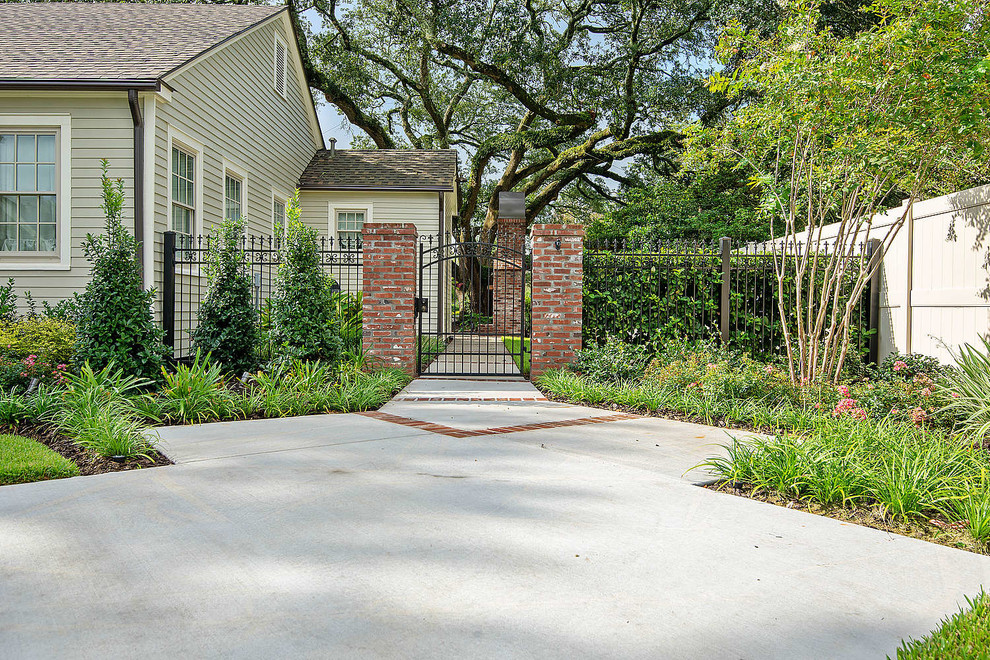 Design ideas for a medium sized classic front driveway partial sun garden in Other with brick paving.