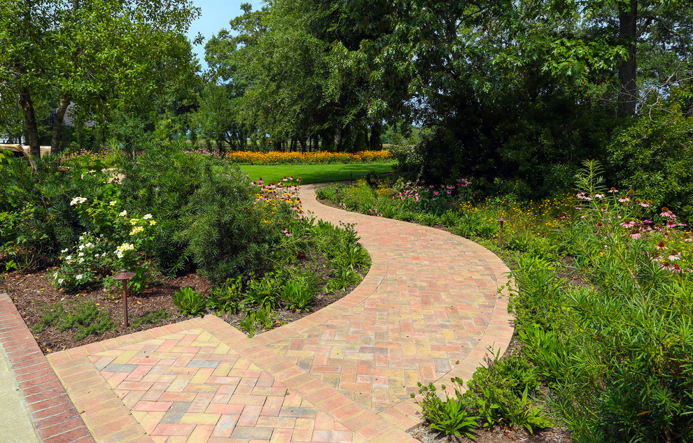This is an example of a contemporary full sun backyard concrete paver garden path in Charleston.