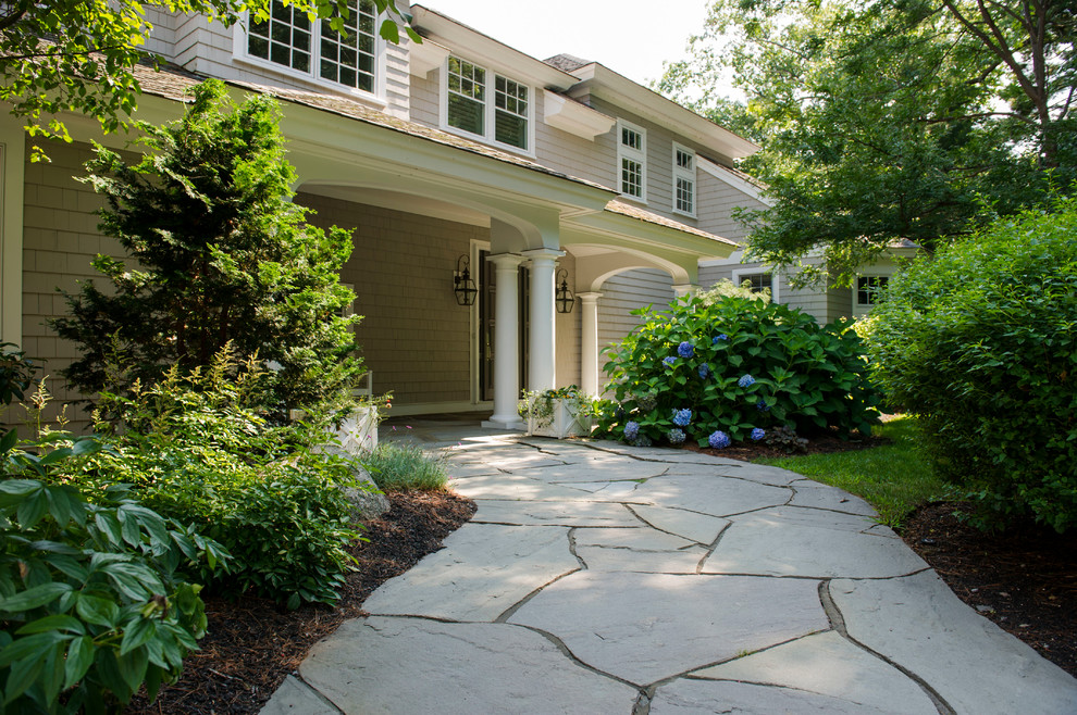 Design ideas for a large traditional partial sun front yard stone landscaping in Boston for summer.