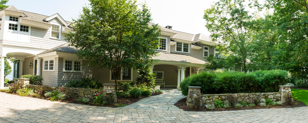 Design ideas for a large traditional shade front yard stone landscaping in Boston for summer.