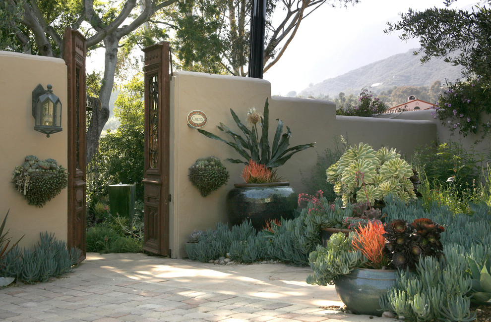 Photo of a mid-sized southwestern partial sun backyard stone landscaping in Santa Barbara.