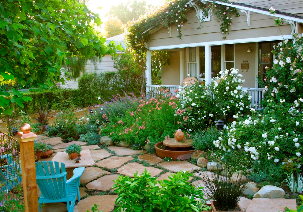 Inspiration for a mid-sized traditional front yard stone landscaping in Santa Barbara.