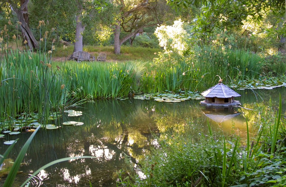 Photo of a large mediterranean backyard gravel pond in Santa Barbara.