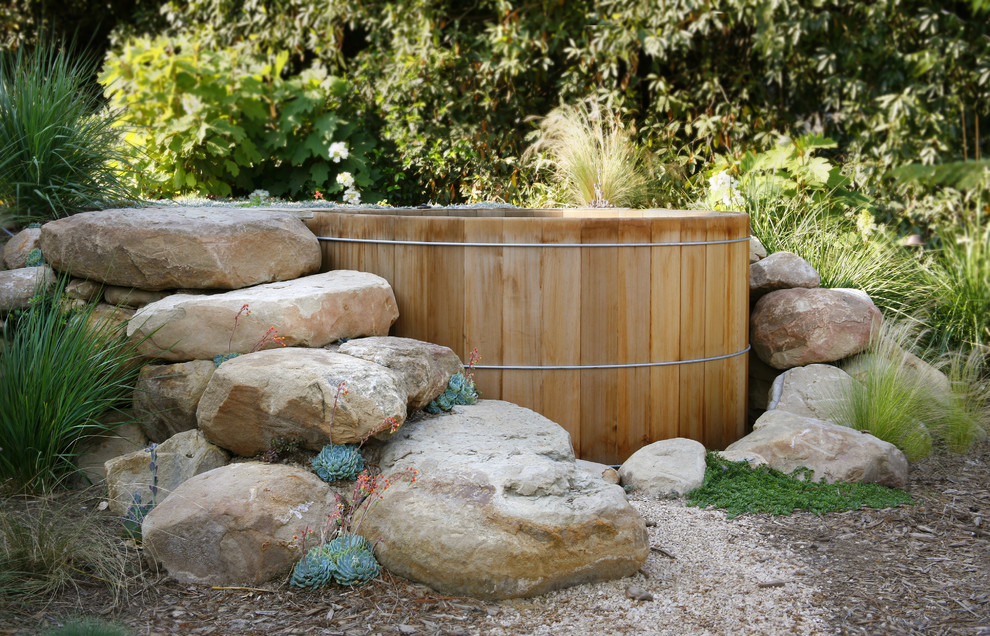 This is an example of a large contemporary drought-tolerant backyard gravel water fountain landscape in Santa Barbara.