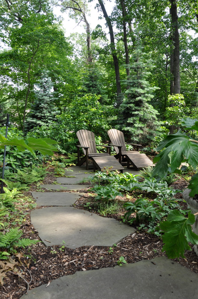Photo of a rustic partial sun garden seating in Atlanta with natural stone paving.
