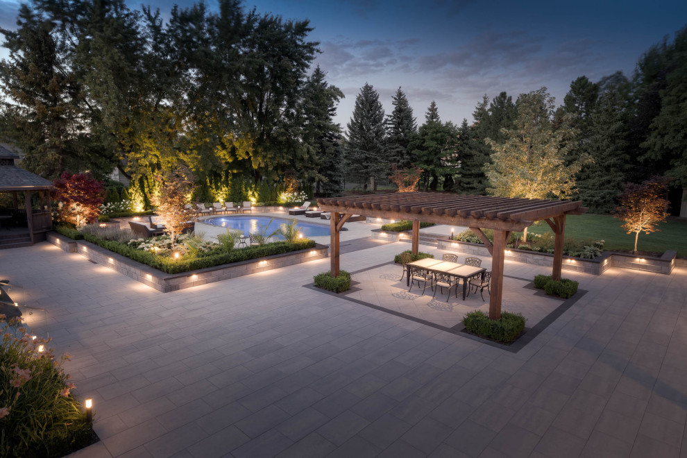 Design ideas for an expansive contemporary back formal full sun garden for summer in Toronto with a raised bed and concrete paving.