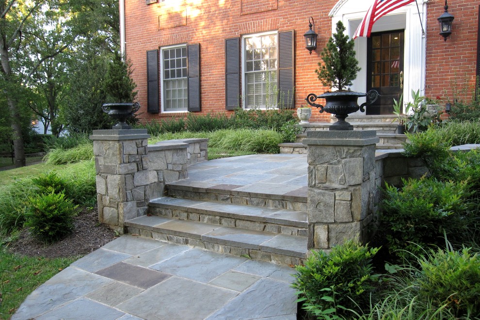Inspiration for a large traditional front formal full sun garden in DC Metro with a garden path and natural stone paving.