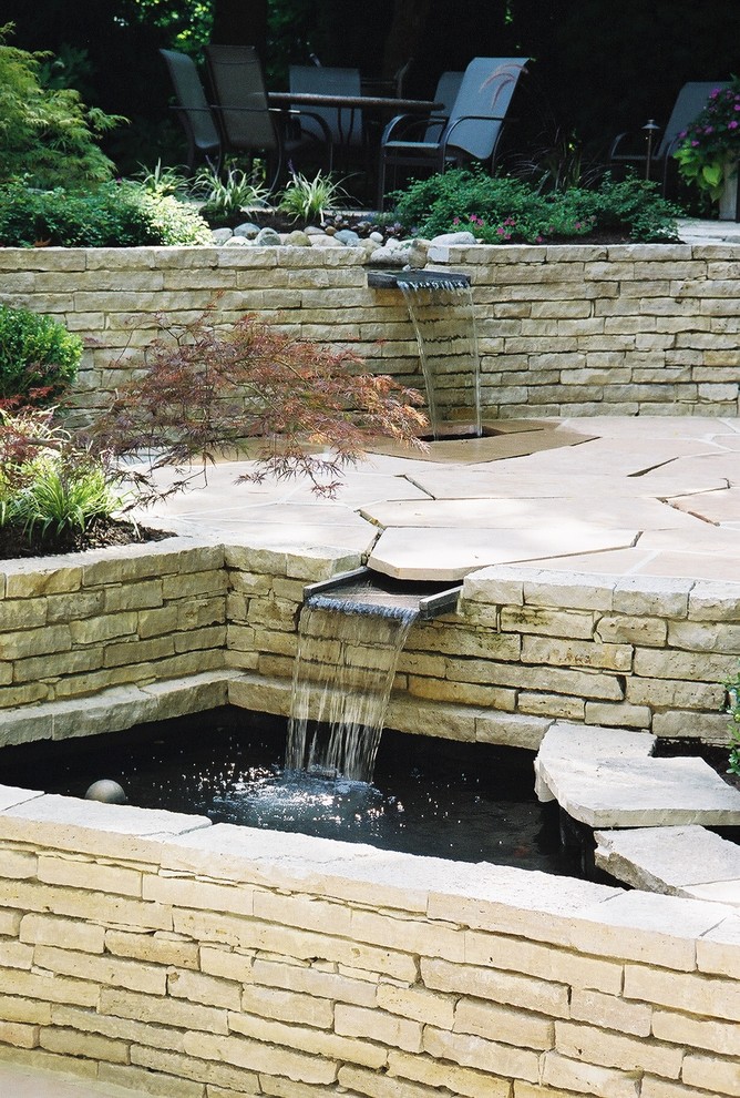 Photo of a medium sized contemporary back formal fully shaded garden in Columbus with a water feature and natural stone paving.